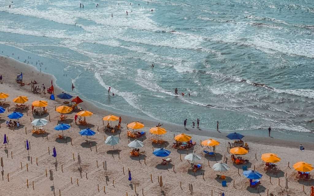 Rows of beach umbrellas and swimmers along the Caribbean coast near Cartagena