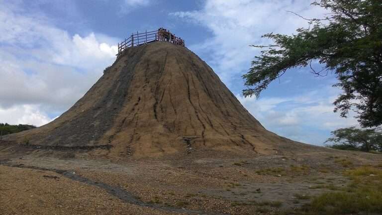 Bathers at the railed crater rim atop the mud volcano of El Totumo